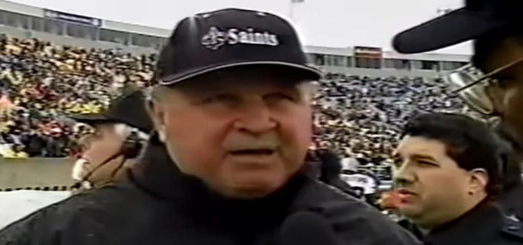 Coach Mike Ditka, head coach of the New Orleans Saints, on the sidelines at Soldier Field in 1999 with Garcia Security.