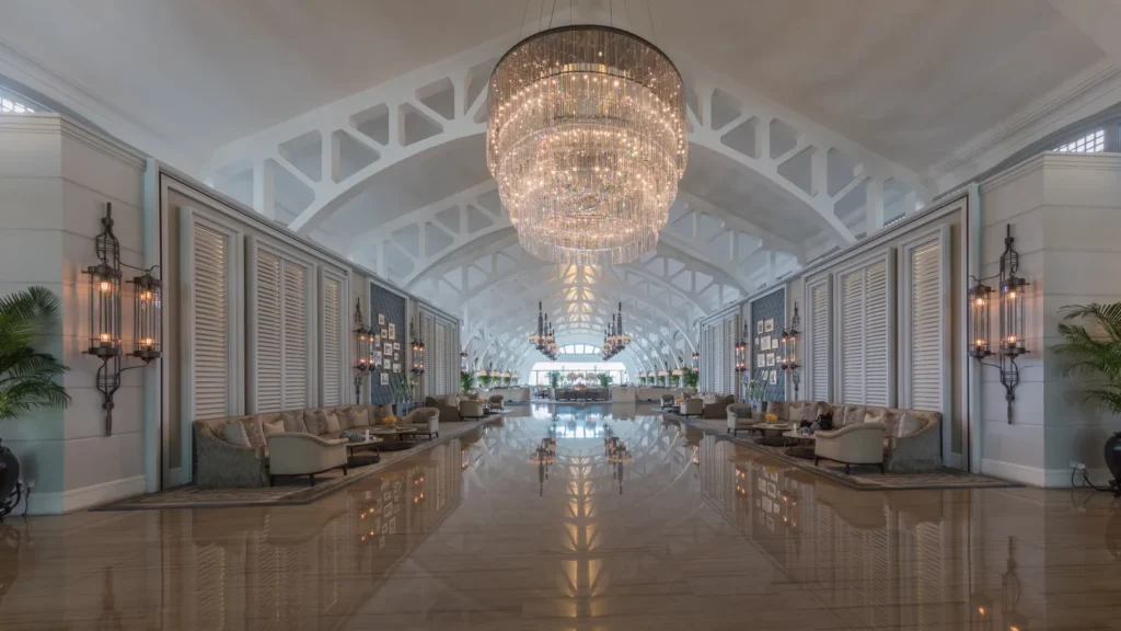 Upscale hotel lobby with a crystal chandelier and lounge seating