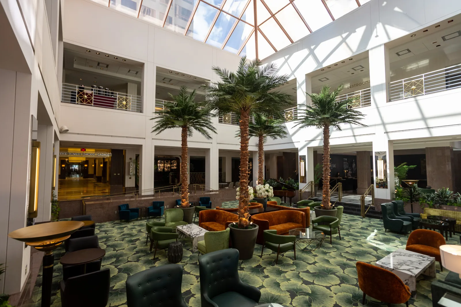 Upscale hotel lobby with seating areas and atrium