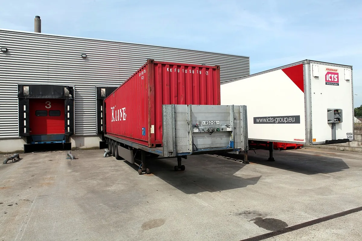 Truck trailers backed into warehouse loading dock doors — warehouse security guards Chicago
